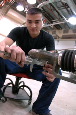 EIELSON AIR FORCE BASE, Alaska -- Airman Jaime Valle, 354th Maintenance Squadron, 354th Fighter Wing, checks the lunette for wear and tear during a 365 inspection on an MHU-141/M Munitions Handling Trailer here on 13 December. The lunette wears down over time due to excessive use. The inspection is a yearly operational and maintenance check on the trailer which can be configured to carry different munition types. 
(U.S. Air Force Photo by Staff Sgt Joshua Strang)