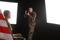 MINOT AIR FORCE BASE, N.D. -- Airman 1st Class Christopher Boitz, 5th Communications Squadron still photographer, takes a studio portrait of an Airman at the multimedia center Wednesday. Airman Boitz is being highlighted as a part of Serving Through the Season, a series running on www.af.mil from Dec. 18 to Jan. 3., for the work he contributes during the holiday season.(U.S. Air Force photo by Airman 1st Class Joe Rivera)