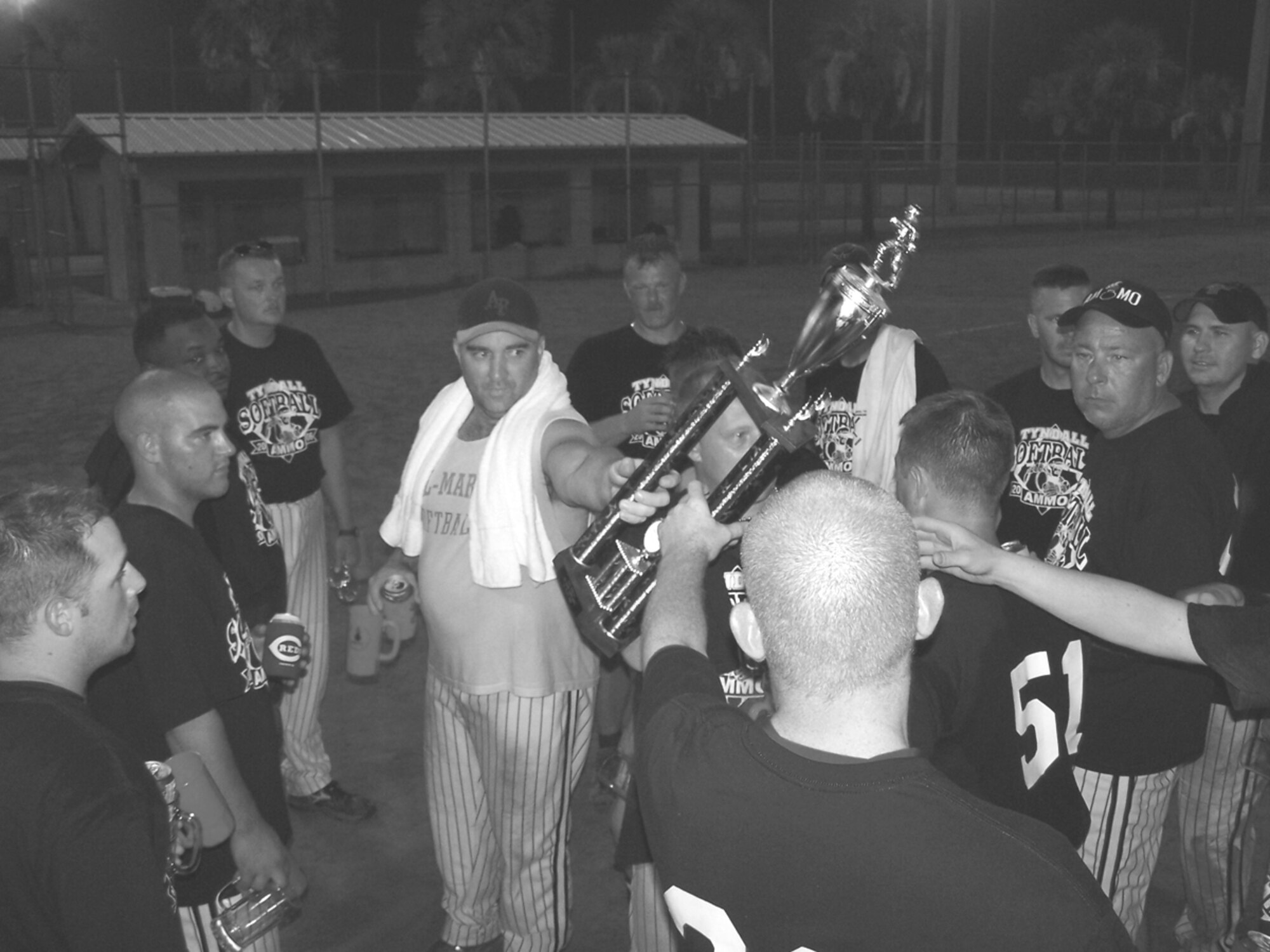 PANAMA CITY, Fla. --  Maj. Eric North passes the trophy to the four-year champions after two days of competition at the eastern Ammo Bowl here.Tyndall's 325th Maintenance Squadron munitions flight softball team won the eastern Ammo Bowl July 31, beating the  Eglin AFB, Fla., team 46-36 in the championship game. (Photo by Senior Airman Thomas Mendiola)