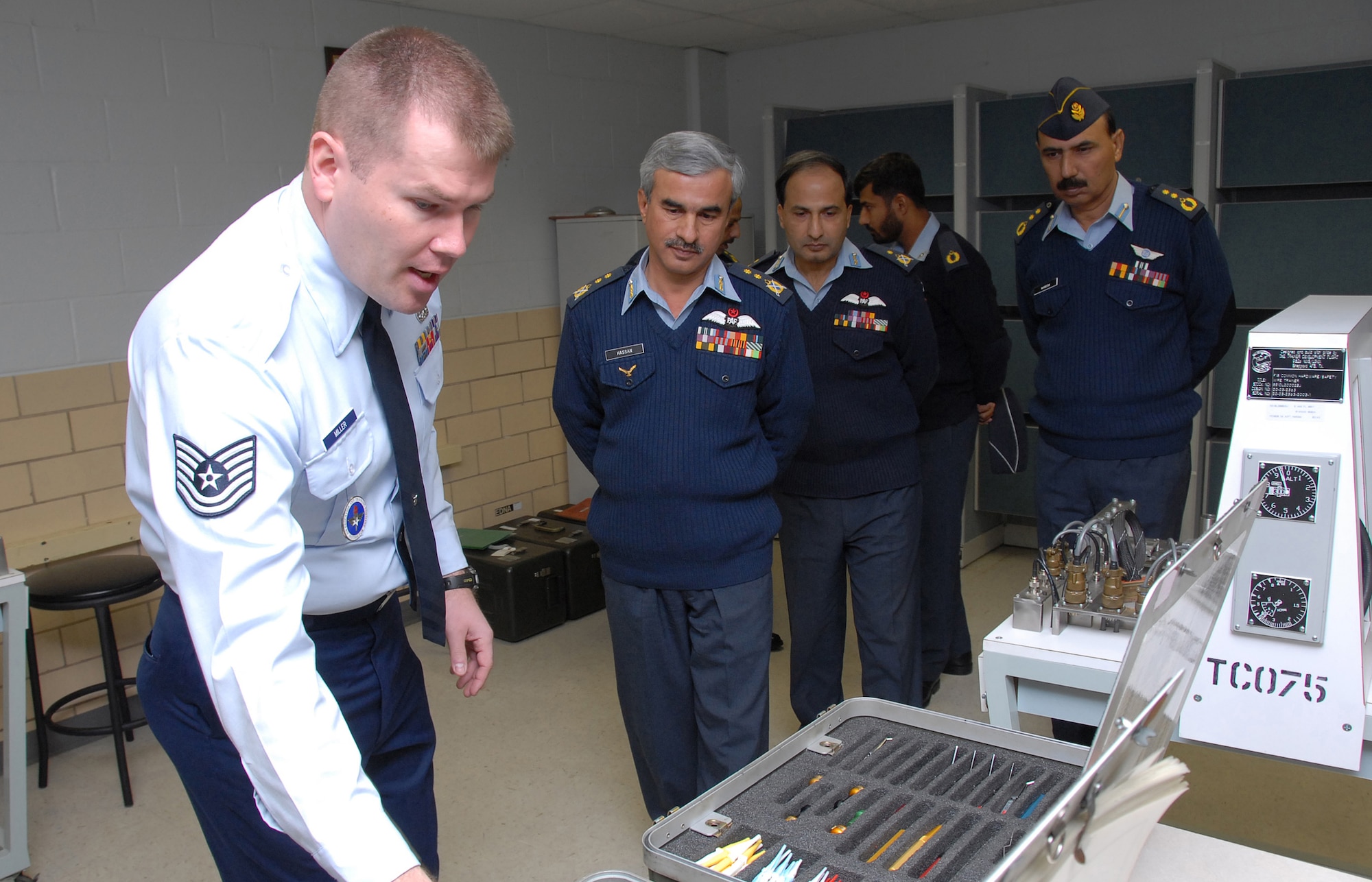 Members of the Pakistan Air Force listen as Tech. Sgt. Eric Miller of the 365th Training Squadron explains how instructors teach Airmen to use the Daniels Kit, a tool used to repair complex wiring systems on F-16s. Also pictured are, from left to right, Air Vice Marshall Muhammad Hassan, Air Commodore Khalid Chishti, Squadron Leader Muhammad Iftikhar and Col. Waseem Medhi. (U.S. Air Force photo/Mike Litteken)