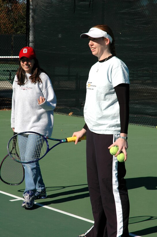 Staff Sgt. Tamara Shaffer, 315th Airlift Wing, coaches a Special Olympics athlete on her tennis serve. (photo by Anthony Clark)