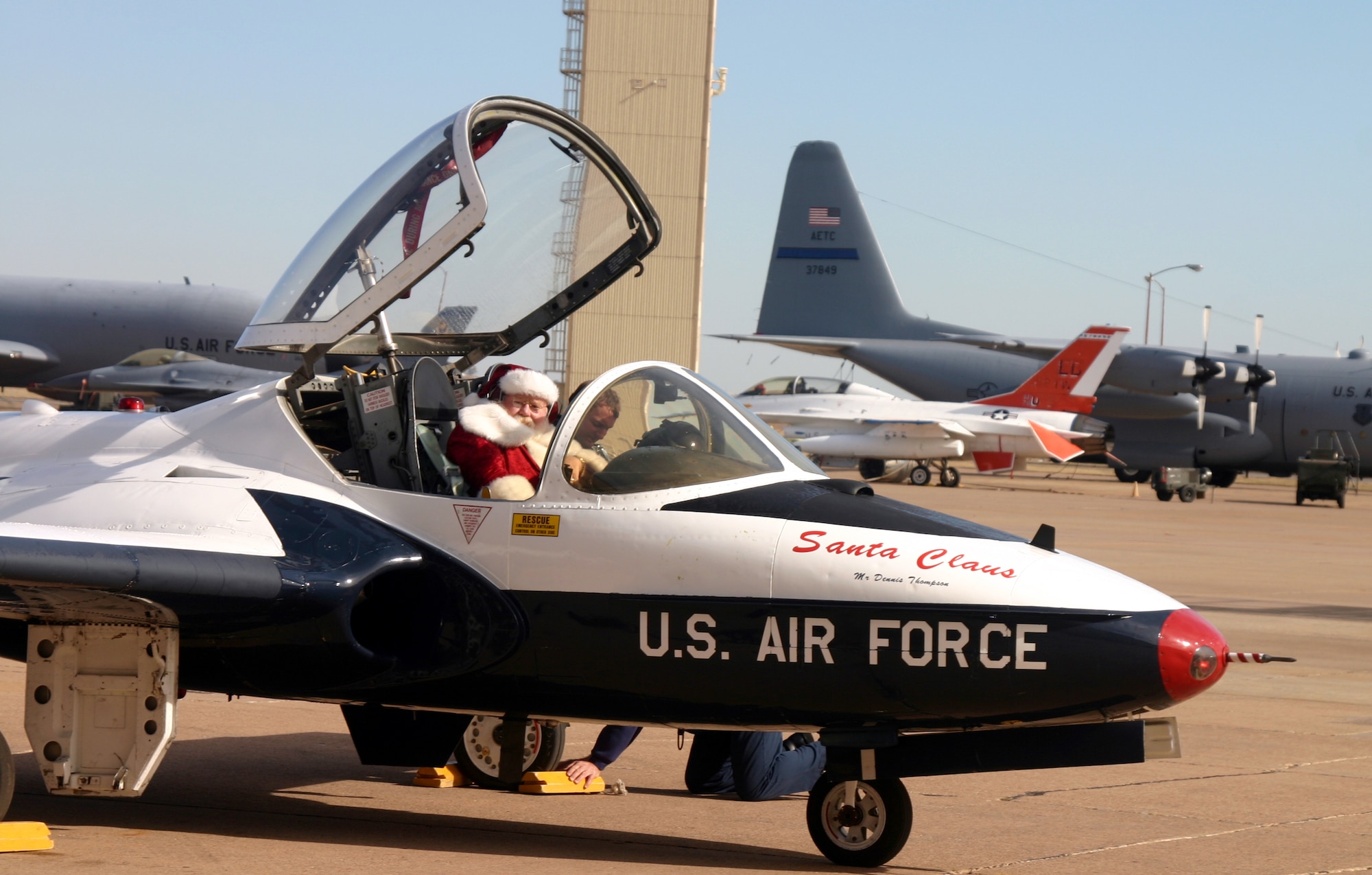 Jolly Old St. Nick arrives at the 10th Annual Give a Child a Christmas party Dec. 8 at Hangar 1080 in a T-37 Tweet. (U.S. Air Force photo/Airman Jacob Corbin)