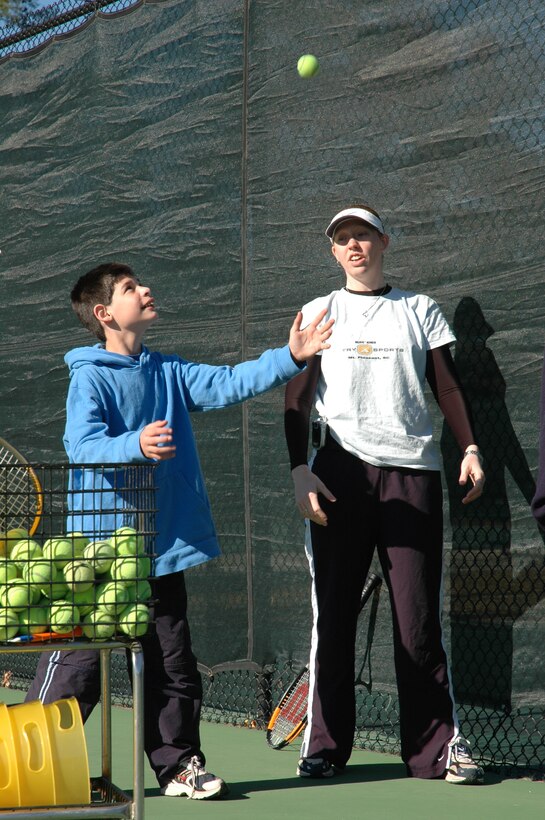 Staff Sgt. Tamara Shaffer, 315th Airlift Wing, coaches a Special Olympics athlete on how to serve a tennis ball. (photo by Anthony Clark)