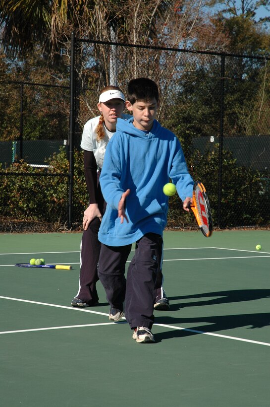 Staff Sgt. Tamara Shaffer, 315th Airlift Wing, coaches a Special Olympics athlete on his forehand. (photo by Anthony Clark)