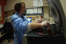 MINOT AIR FORCE BASE, N.D. – Tech. Sgt. Jessica Fabacher, 5th Medical Support Squadron laboratory technician, loads blood vials into a centrifuge on December 11, 2006. A centrifuge spins the blood around to separate red blood cells from the plasma. (U.S. Air Force photo by Airman 1st Class Joe Rivera)