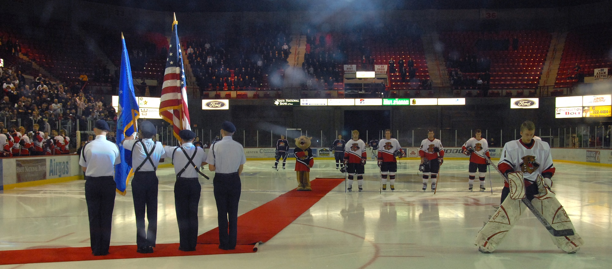 Members of the Sheppard Airmen-in-training drill team participate in the opening ceremonies of the Wichita Falls Wildcats military appreciation night game. (U.S. Air Force photo/Mike Litteken.)