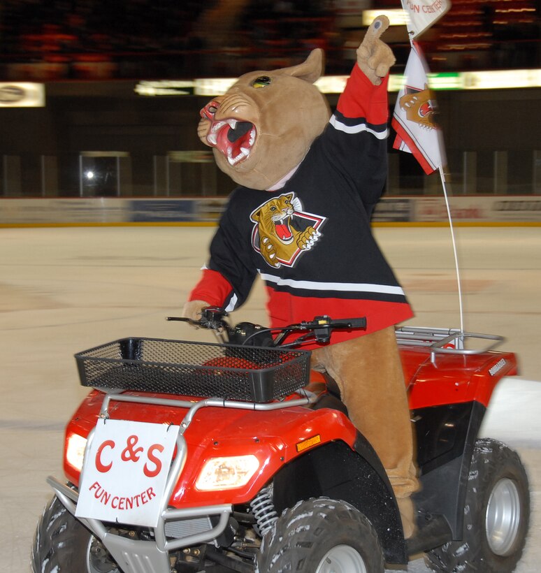 The Wichita Falls Wildcats mascot, Craze E. Cat, rides an all-terrain vehicle during a break in play at the Wildcats military appreciation night. (U.S. Air Force photo/Mike Litteken.)