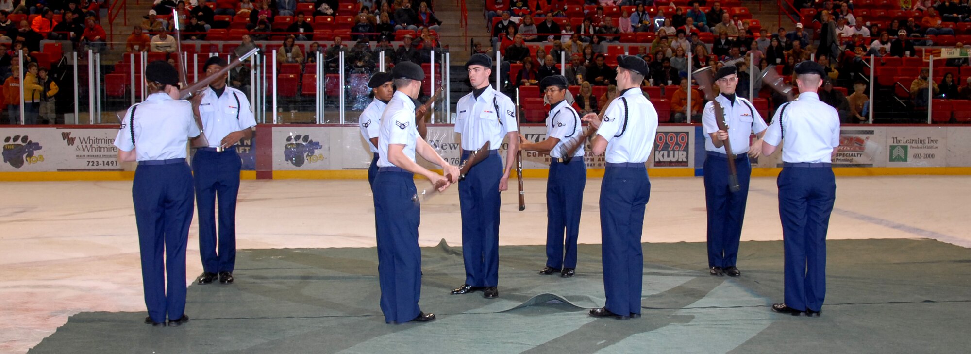 Members of Sheppard’s Airmen-in-training rifle team perform between periods at the Wichita Falls Wildcats military appreciation night Dec. 8. (U.S. Air Force photo/Mike Litteken.)