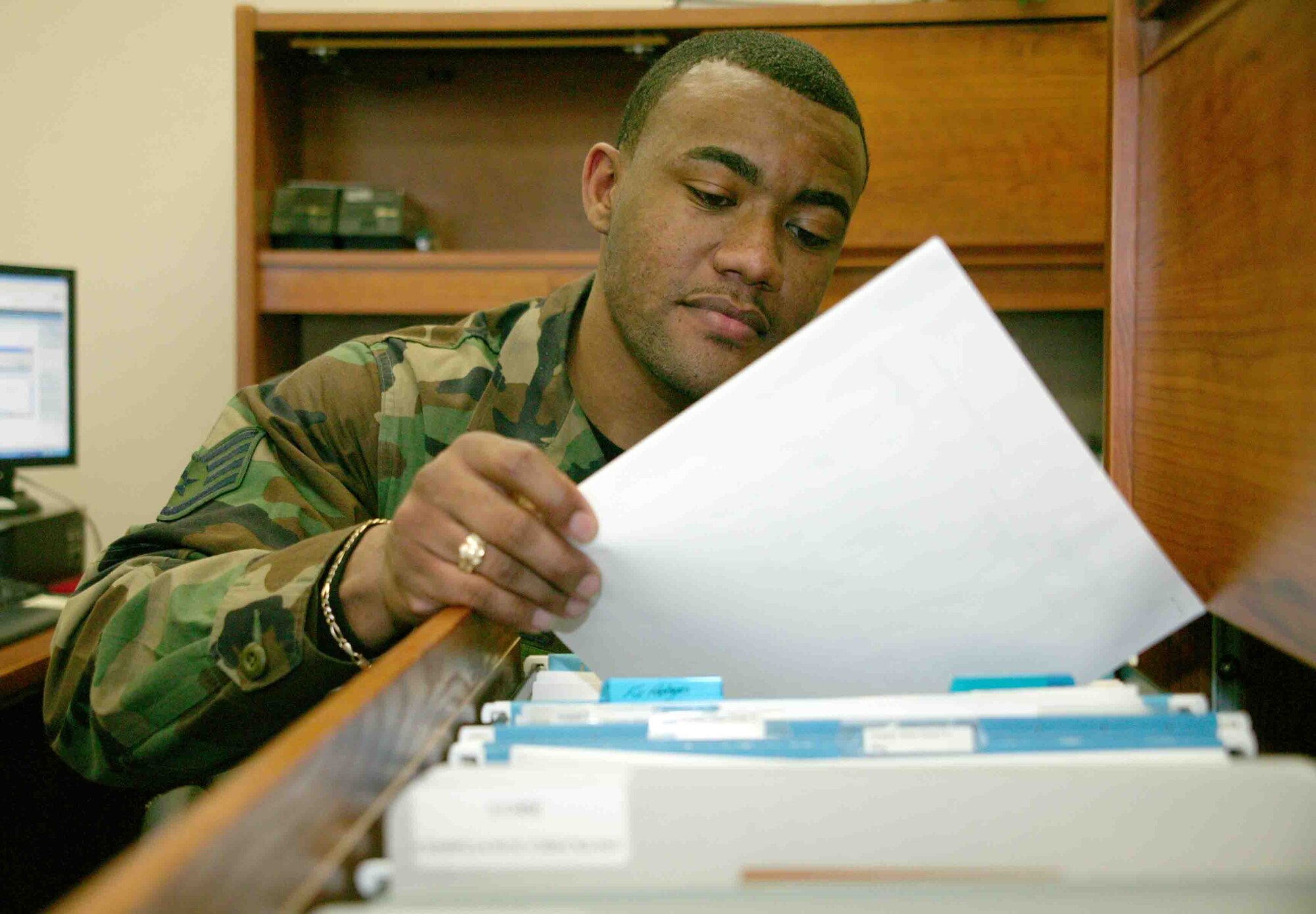 SHAW AIR FORCE BASE, S.C. -- Staff Sgt. Antoine Brookes, 20th Logistics Readiness Squadron procedure and analysis representative, reviews outprocessing forms Dec. 12.  (U.S. Air Force photo/Senior Airman John Gordinier)