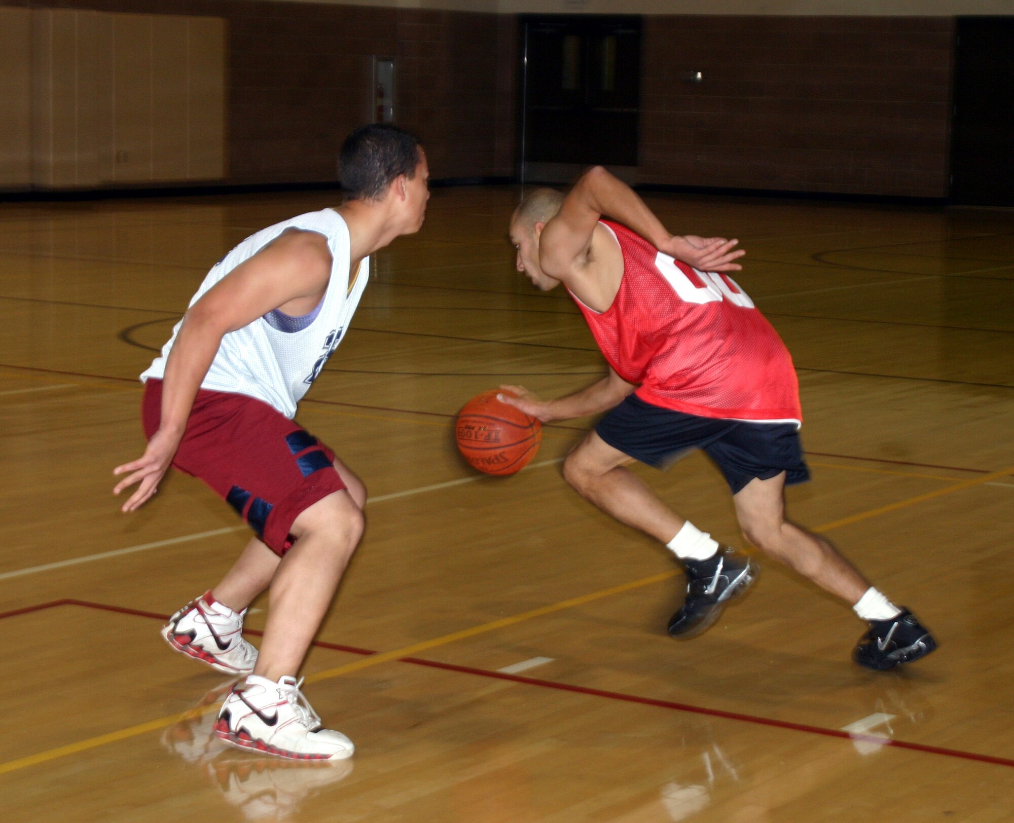 Milo Gardea from the Sheppard Fire Department moves to evade an opponent in an intramural basketball game between the 82nd Communications Squadron and the SFD Tuesday at the Levitow Fitness Center. (U.S. Air Force photo/Airman Jacob Corbin).