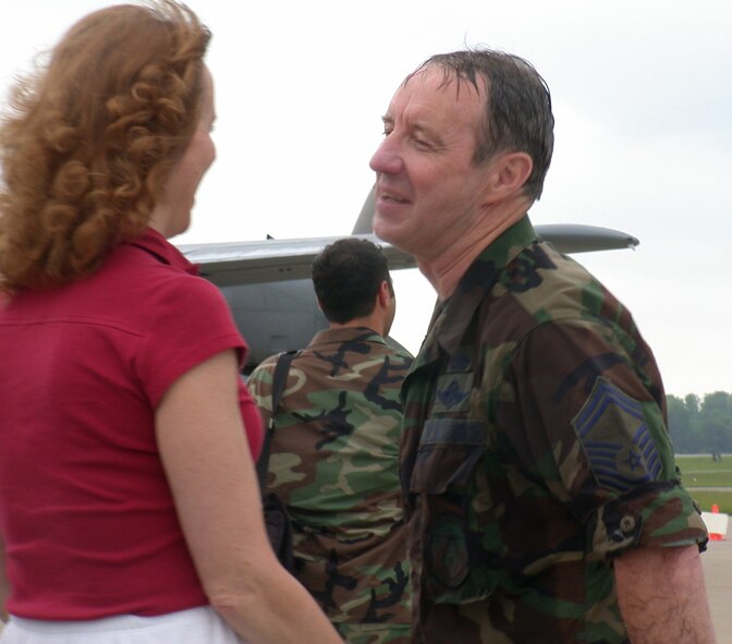 YOUNGSTOWN AIR RESERVE STATION, Ohio--Air Force Reserve Senior Master Sgt. William A. Rooks Jr., chief of Aerial Spray Maintenance at the time, is greeted by his wife Korene after his last aerial spray mission May 28, 2004.  Sergeant Rooks is known as the pioneer of aerial spray maintenance, transferring to Youngstown Air Reserve Station from Rickenbacker Air National Guard Base in Columbus, Ohio with the spray mission in 1991.  U.S. Air Force photo/Tech. Sgt. Ken Sloat