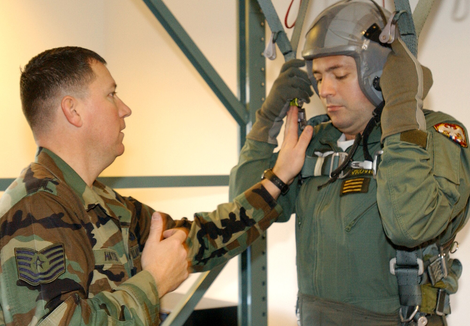 Tech. Sgt. Rusty Hayes, 31st Operations Support Squadron, helps Serbian air force Capt. Vladimir Ivkovic, with his flight gear prior to an F-16 orientation flight.  (Photo by Airman 1st Class Liliana Moreno) 