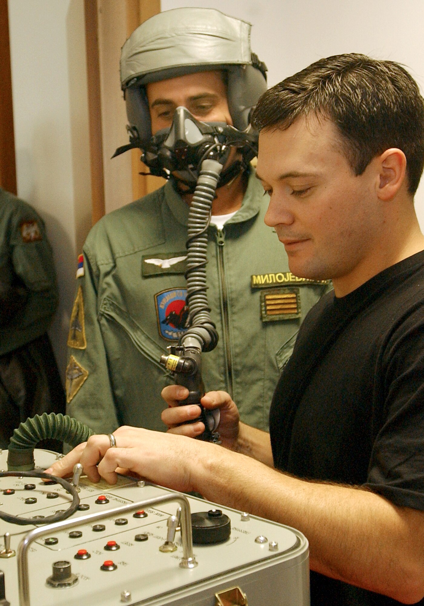 Staff Sgt Daniel Daugherty, 510th Fighter Squadron, checks Serbian air force Capt. Nenad Milojevic’s, mask for leaks. (Photo by Airman 1st Class Liliana Moreno) 