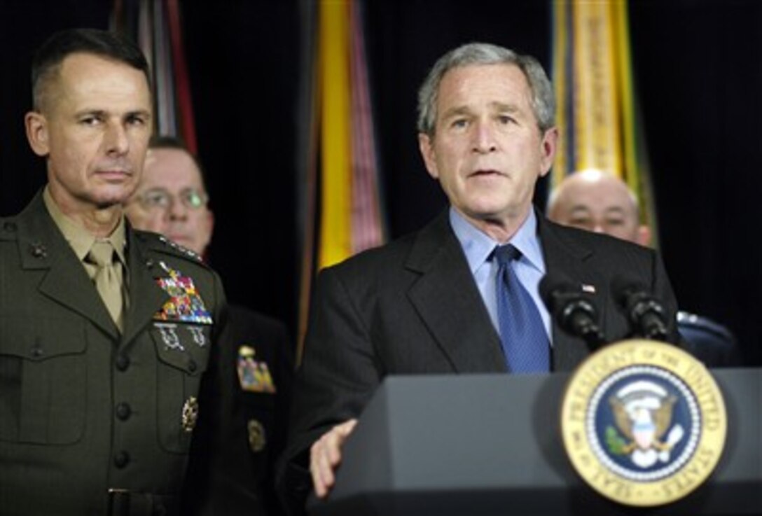 President George W. Bush delivers remarks to the press on the new way forward in Iraq as Chairman of the Joint Chiefs of Staff Marine Gen. Peter Pace and other defense officials listen at the Pentagon, Dec. 13, 2006.