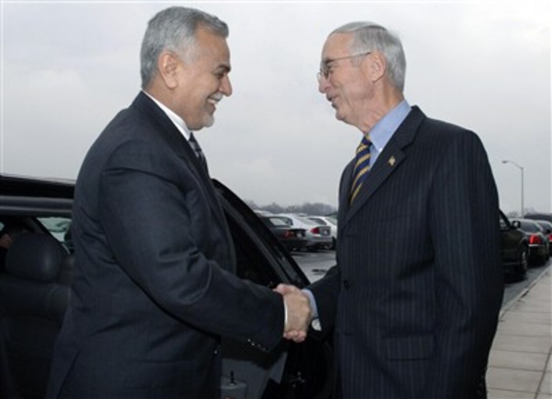 Deputy Secretary of Defense Gordon England, right, greets Iraqi Vice President Traq Al-Hashimi at the Pentagon, Dec. 13, 2006.