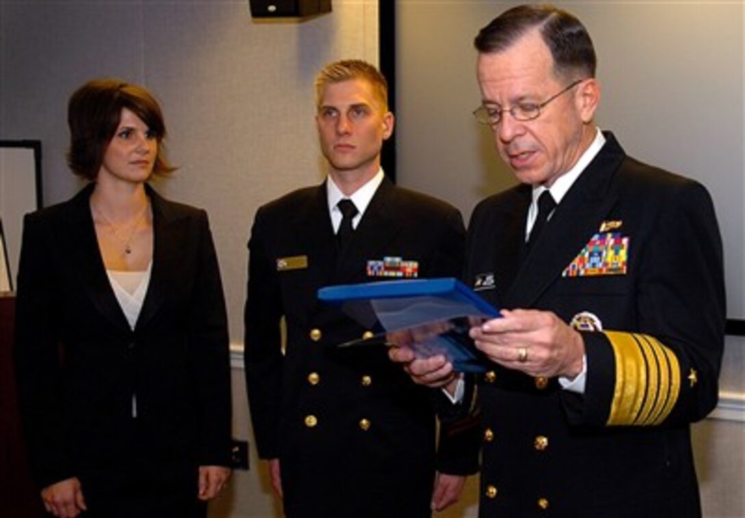 Chief of Naval Operations Adm. Mike Mullen meritoriously promotes Chief Cryptologic Technician Brian Davison, one of the Navy’s 12 Enlisted Recruiters of the Year, at the Pentagon as his wife looks on, Dec. 12, 2006.