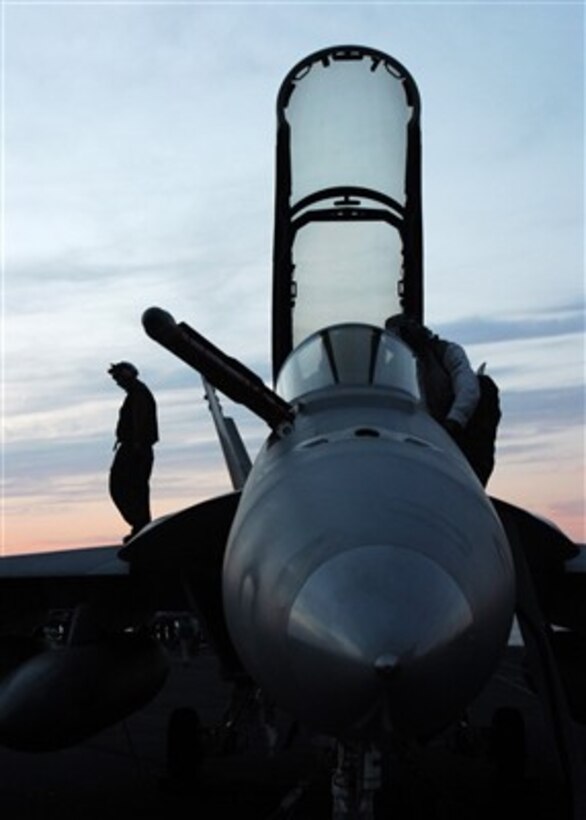 U.S. Navy sailors perform checks on an F/A-18F Super Hornet aircraft aboard the Nimitz-class aircraft carrier USS Dwight D. Eisenhower (CVN 69) on Dec. 8, 2006.  The Eisenhower is on deployment in support of maritime security operations.  