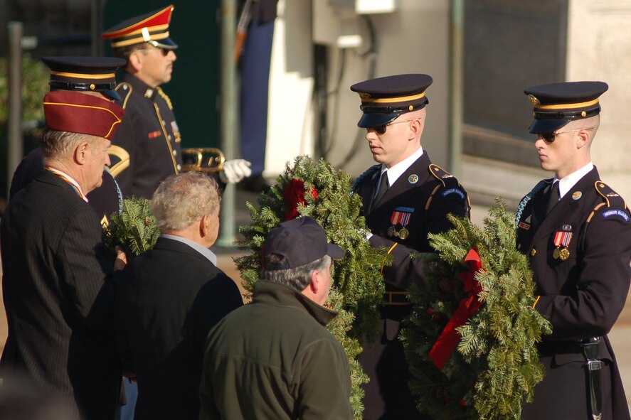 Two Soldiers recieve wreaths to lay at the Tomb of the Unknown Soldier, Arlington National Cemetary, Va., Dec. 14. The soldiers laid four wreaths at the tomb in an official ceremony. 