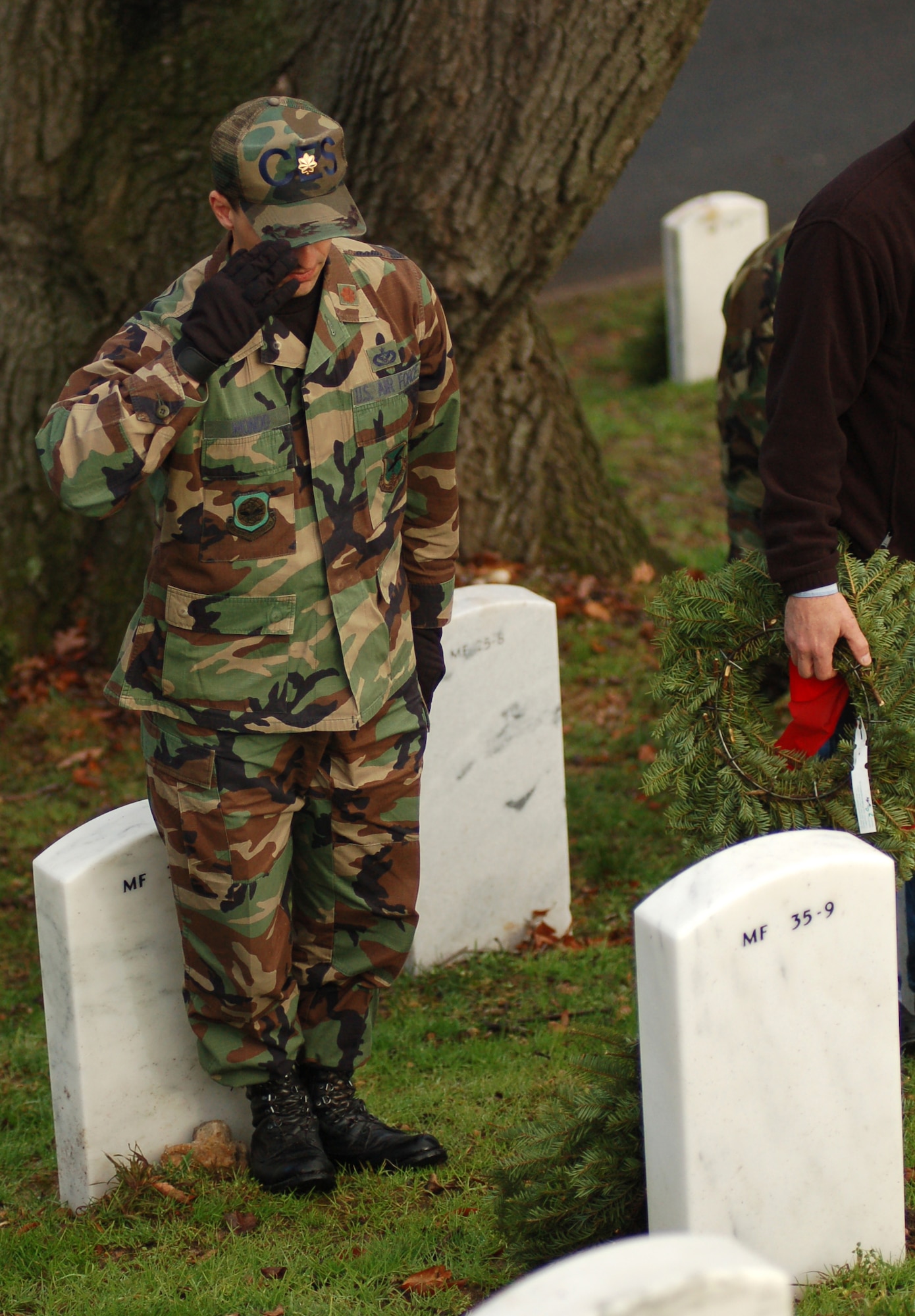 Maj. Frank Mondo, 436th Civil Engineer Squadron, salutes the grave he just laid a wreath on Dec. 14 at Arlington National Cemetary, Va. Major Mondo was one of 44 Dover Air Force Base, Del., Airmen who volunteered to lay 5,000 wreaths at the cemetary to honor those servicemembers who passed away. (U.S. Air Force photo/Senior Airman James Bolinger)