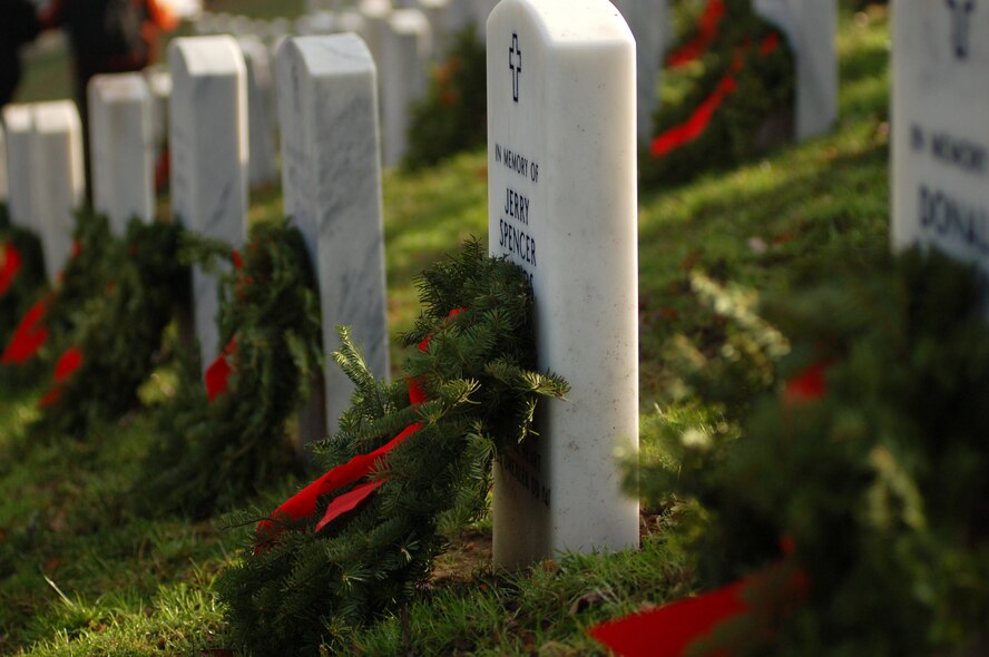 A wreath leans against a grave at Arlington National Cemetary, Va., Dec. 14. Fourty-four Dover Air Force Base, Del., Airmen along with hundreds of other volunteers lead 5,000 wreaths in Section 3 of the cemetary to honor servicemembers who have passed away. (U.S. Air Force photo/Senior Airman James Bolinger)