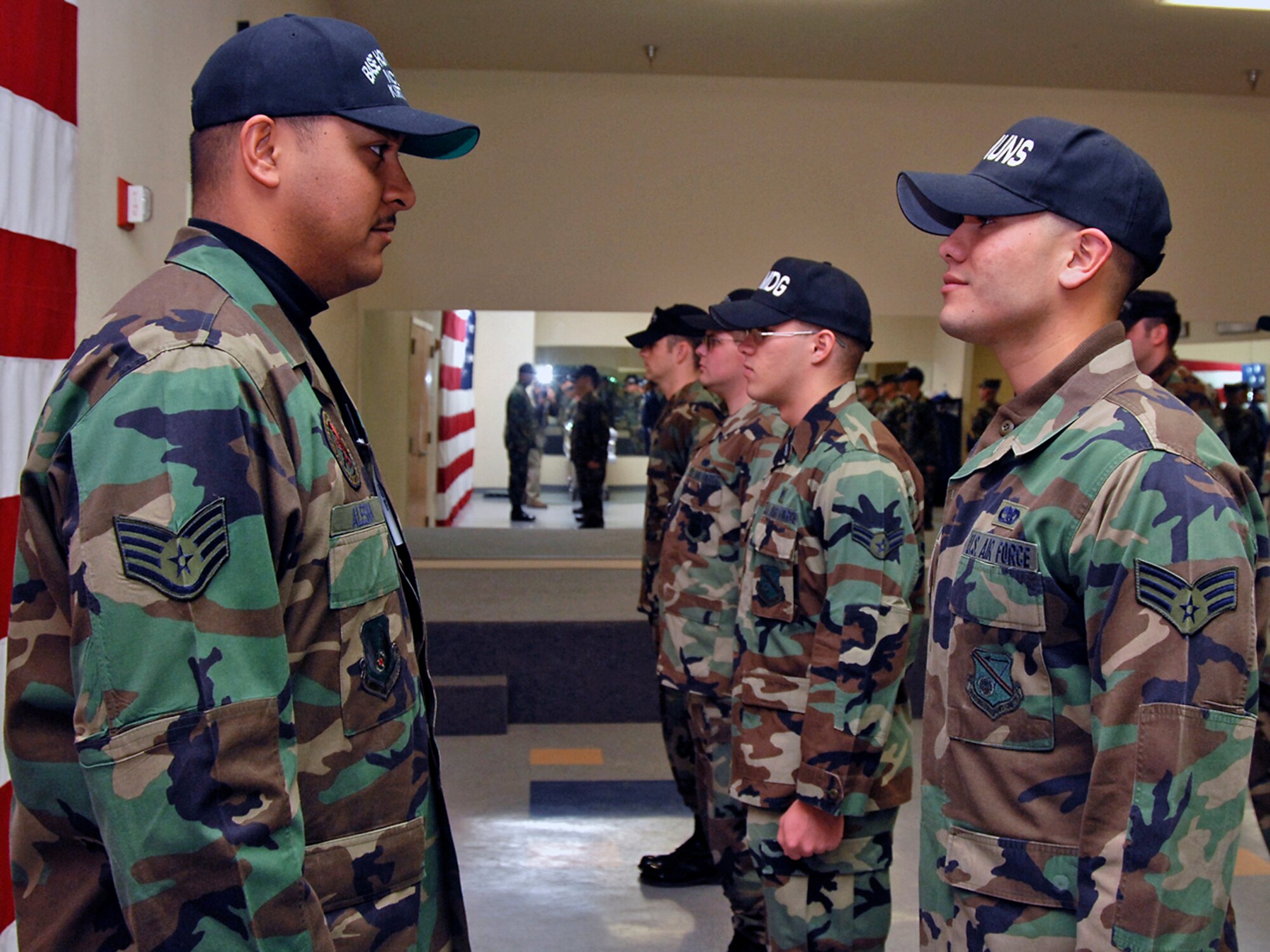 Staff Sgt. Kamuela Alesna, new noncommisioned officer in charge of the Kirtland Honor Guard, conducts an open ranks inspection of Senior Airman Juan Garcia, 898th Munitions Squadron. (U.S. Air Force photo by Todd Berenger)