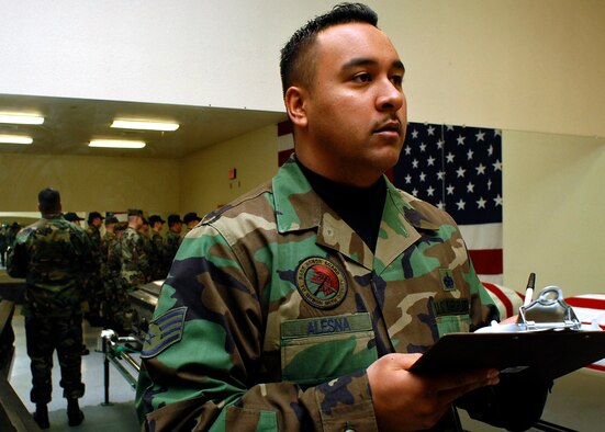 Staff Sgt. Kamuela Alesna, new noncomissioned officer in charge of the Kirtland Honor Guard, prepares to begin the morning briefing with members of the honor guard. Although the position was advertised to technical sergeants and master sergeants, Sergeant Alesna's professionalism and leadership earned him the slot. (U.S. Air Force photo by Todd Berenger)