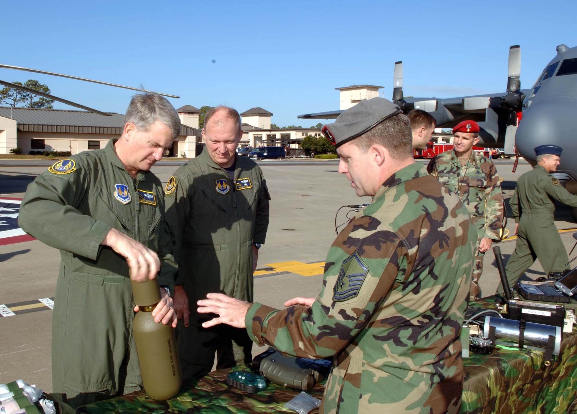 Brigadier Generals David Eichhorn (left) and Mike Wilson examine the equipment of an Air Force Special Operations combat weathermen during a static display on the Hurlburt Field flightline Dec. 13. The display was one of the final events during the Air Force A3 conference held here. (U.S. Air Force Photograph by Senior Airman Andy Kin)
