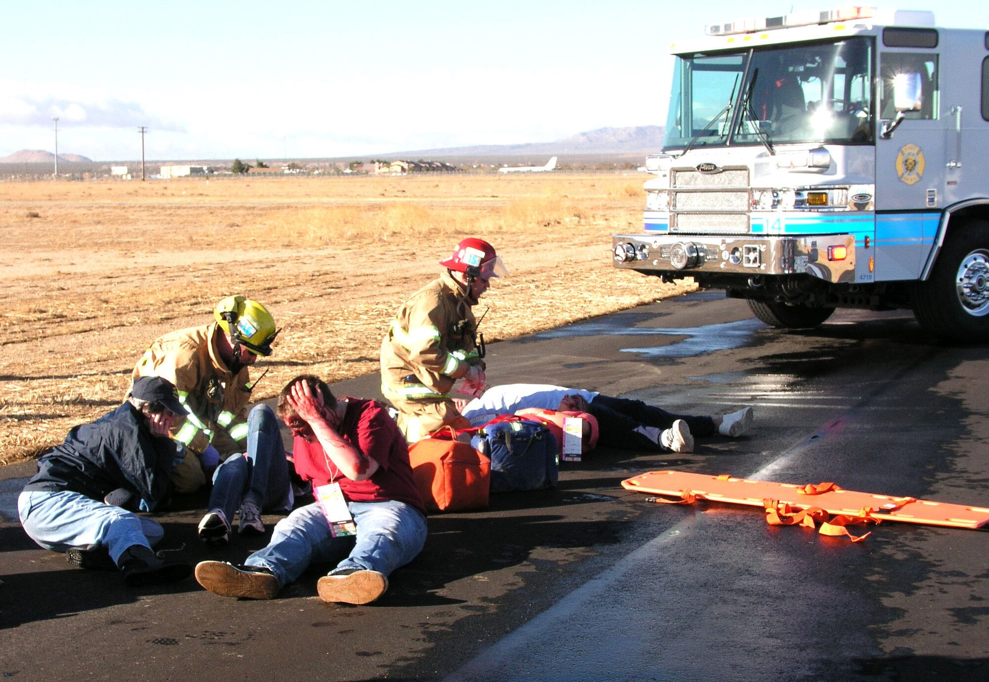 MOJAVE, Calif. — Kern County and Edwards Air Force Base firefighters triage civilian victims of a simulated B-1B bomber crash at Mojave Spaceport in Mojave, Calif. on Dec. 10, 2006. The joint exercise kicked off Edwards' Operational Readiness Exercise, which ended Dec. 14. (Photo by John Haire)