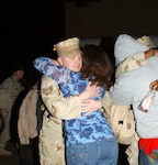 Staff Sgt. Michael Garrett, 12th Flying Training Wing Security Forces, greets his wife, Lauri, upon returning from a six-month deployment to Eskan Village, Kingdom of Saudi Arabia. (Photo by Staff Sgt. Beth Del Vecchio)