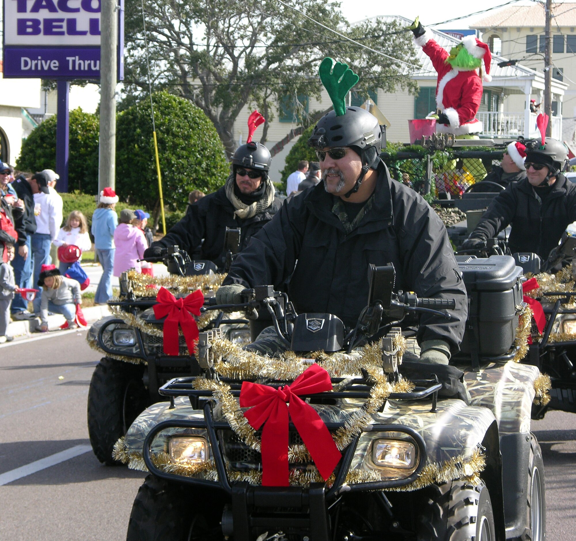 The Grinch Who Stole Christmas was escorted during the Destin Christmas parade Dec. 9 by members of the 1st Special Operations Support Squadron. Many squadrons and equipment from Hurlburt Field participate in the parade every year. (U.S. Air Force Photograph by 2nd Lt. Lauren Johnson)
