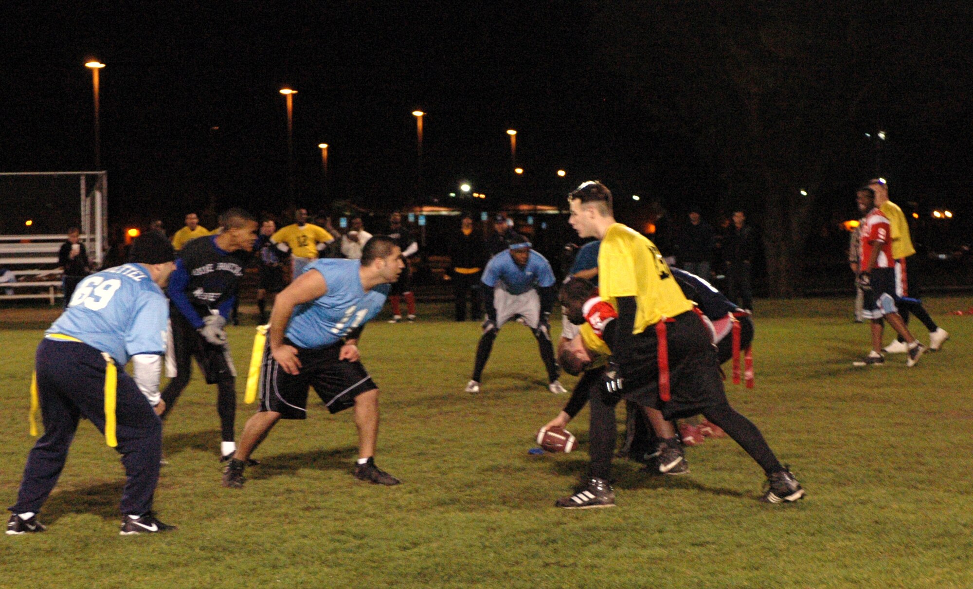 The 60th Security Forces Squadron (gold) gets set to run a play against the 60th Operations Support Squadron (blue) during the flag football season championship, Dec. 6. The 60th SFS, using aggressive defense, was able to narrowly defeat the 60th OSS by a score of 7 to 6. (U.S. Air Force photo by Staff Sgt. Candy Knight)