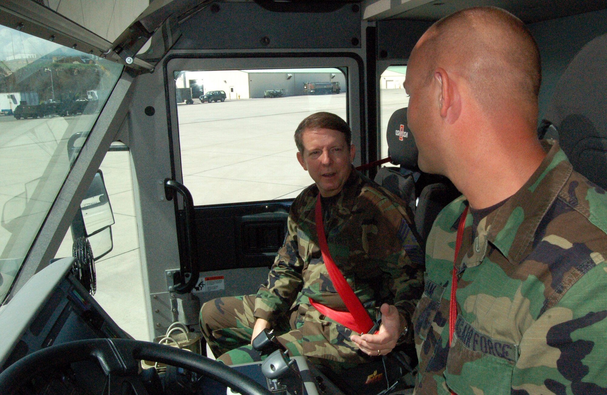 Chief Master Sgt. of the Air Force Rodney J. McKinley talks to firefighter Staff Sgt. Ron Wareham about his fire truck Dec. 14 at Forward Operating Location Curacao, Netherlands Antilles. The chief stopped at the base to receive a mission orientation, talk to Airmen about Air Force issues, and spread some holiday cheer. Sergeant Wareham is a guardsman deployed to Curacao from the 174th Fighter Wing at Syracuse, N.Y. (U.S. Air Force photo/Louis A. Arana-Barradas) 
