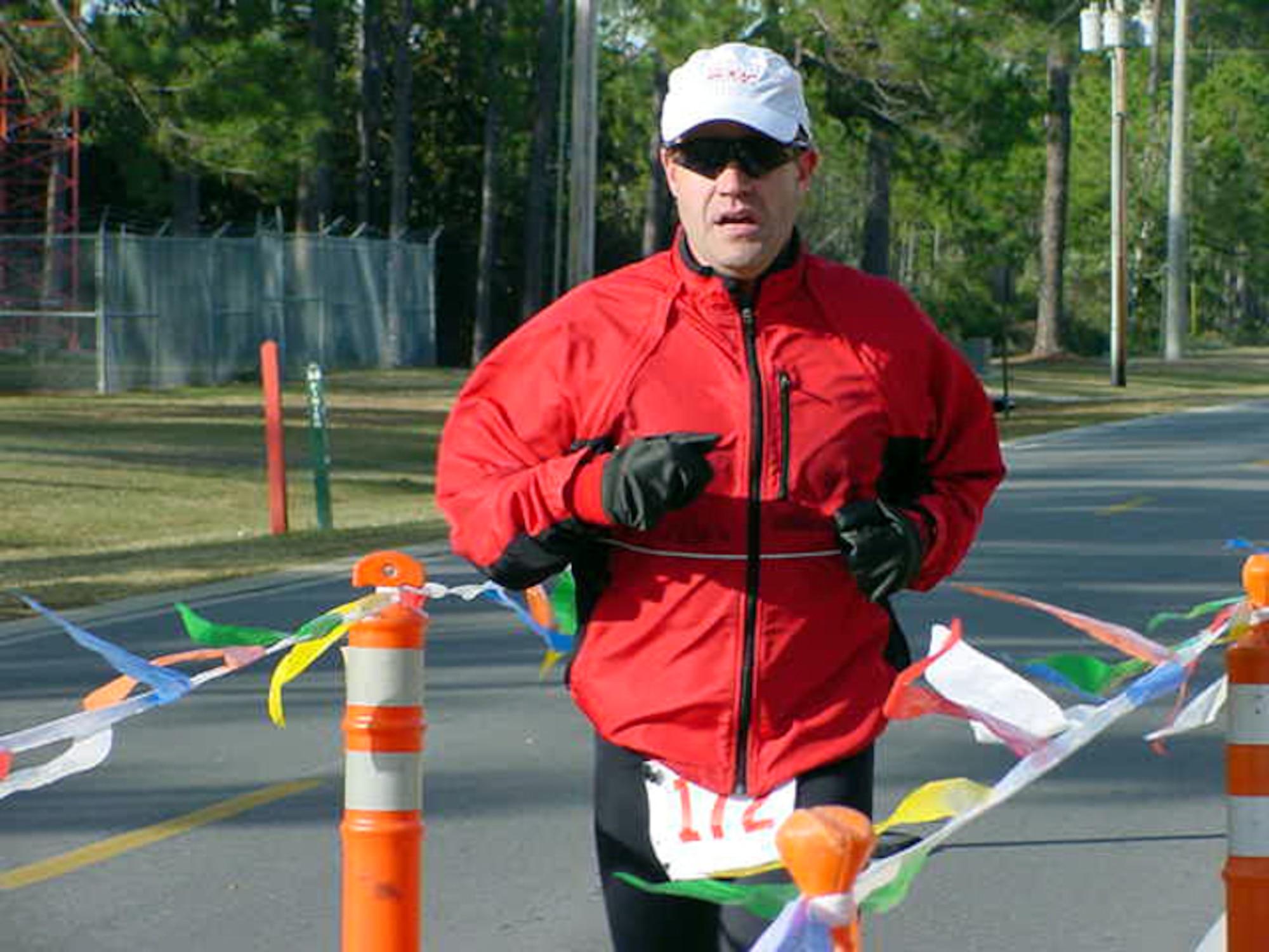 Chris Hicks crosses the finish line at the first-ever 1st Special Operations Services Squadron half-marathon Dec. 9 at Hurlburt Field.  Temperatures dipped in the 30s for the runners who braved the cold and 13.1-mile distance. (U.S. Air Force Photograph by Senior Airman Courtney Blitch)