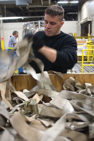Tech. Sgt. Ted Braun, 437th Aerial Port Squadron air transportation specialist, sorts  through pallet straps at the port’s warehouse Dec. 11. (U.S. Air Force photo/Airman 1st Class Sam Hymas)