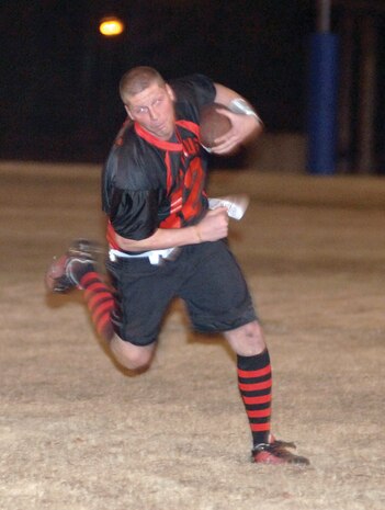 Brandon Barnes, Outlaws quarterback, runs the ball during the game. Barnes connected with receivers three times in the end zone. (U.S. Air Force photo/Staff Sgt. Marie Cassetty)