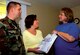 SEYMOUR JOHNSON AIR FORCE BASE, N.C. - Staff Sgt. Corey Middleton, 4th Equipment Maintenance Squadron, and his wife receive an information gift bag from Marcia Sampson, 4th Fighter Wing life skills outreach nurse, as part of the Born Learning Program, which provides information to parents on educating newborn children. (U.S. Air Force photo by Airman 1st Class Greg Biondo)