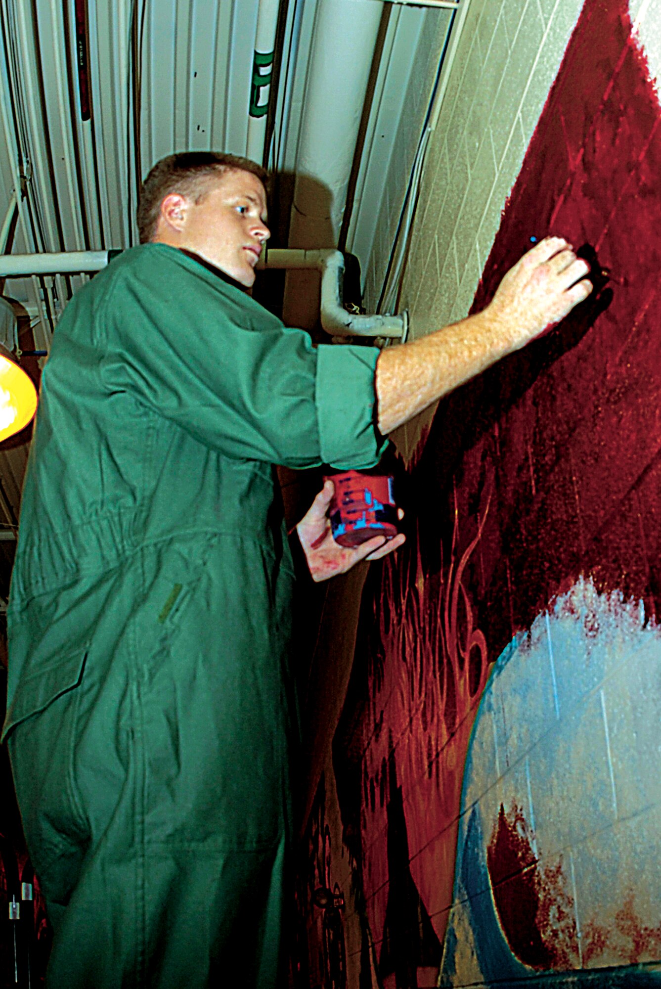 SEYMOUR JOHNSON AIR FORCE BASE, N.C. - Airman 1st Class William McGowan paints a mural at the 4th Equipment Maintenance Squadron headquarters building on hangar row. (U.S. Air Force photo by Airman 1st Class Greg Biondo)