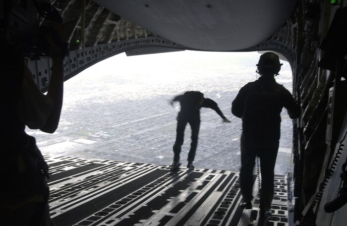 Al Vernon, the fourth and final member of the U.S. Special Operations Command Parachute Demonstration Team from MacDill Air Force Base, Fla., jumps from the ramp of a CHarleston Air Force Base C-17 Globemaster III over the Miami Dolphins football game Oct. 10. (U.S. Air Force photo/Tech. Sgt. Paul Kilgallon)