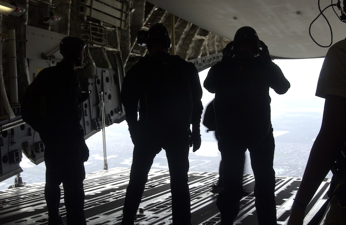 Chip Bowlin, Al Vernon, Andy Burch and Andy Serrano await the green light indicating they are over their jump zone before their jump from a Charleston Air Force Base C-17 Globemaster III over the Miami Dolphins football game Oct. 10. Mr. Serrano, Mr. Burch, Mr. Vernon and Mr. Bowlin are retired Soldiers who volunteer as members of the U.S. Special Operations Command Parachute Demonstration Team from MacDill Air Force Base, Fla. (U.S. Air Force photo/Tech. Sgt. Paul Kilgallon)