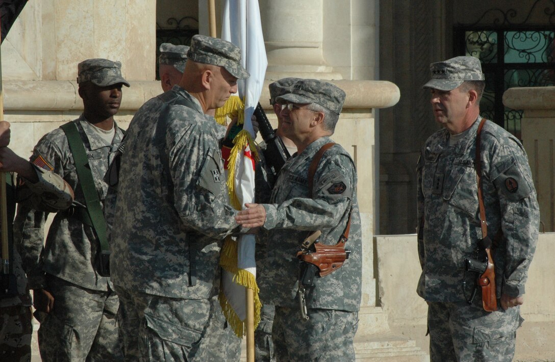 From right: U.S. Army Lt. Gen. Peter Chiarelli, commanding general of 5th Corps, looks on as Gen. George W. Casey Jr., commanding general of Multi-National Force – Iraq, congratulates Lt. Gen. Ray Odierno, commanding general of 3rd Corps, during a ceremony marking the transfer of authority over Multi-National Corps - Iraq from 5th Corps to 3rd Corps at Al Faw Palace, Camp Victory, Iraq, Dec. 14, 2006.