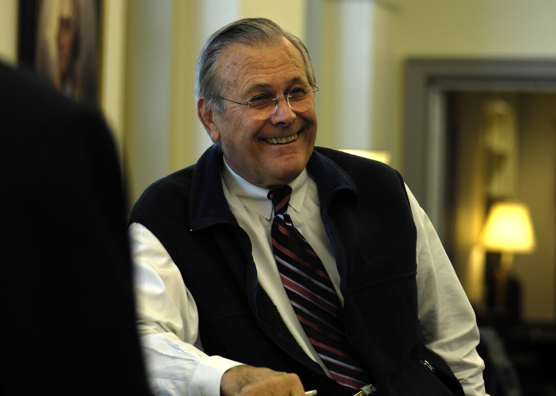 Defense Secretary Donald H. Rumsfeld shares a laugh during his final morning stand up meeting with key members of his staff in his office at the Pentagon, Dec. 15, 2006.