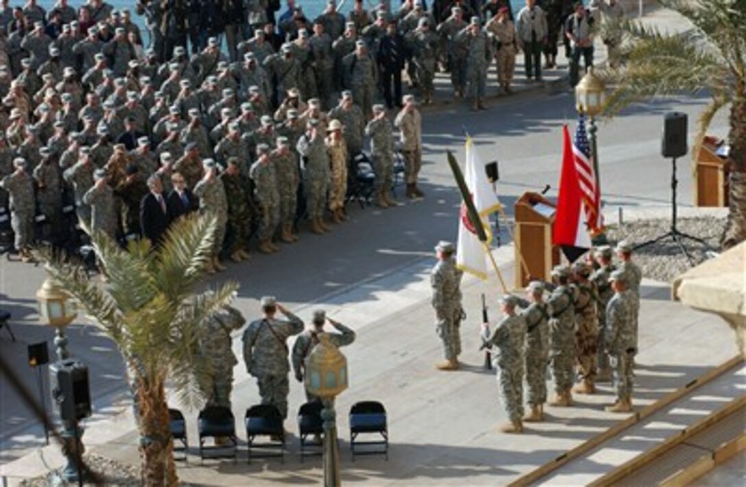 U.S. servicemembers of Multi-National Corps-Iraq salute during the playing of the Iraqi National Anthem during a ceremony marking the transfer of authority over Multi-National Corps - Iraq from V Corps to III Corps at Al Faw Palace, Camp Victory, Iraq, Dec. 14, 2006.