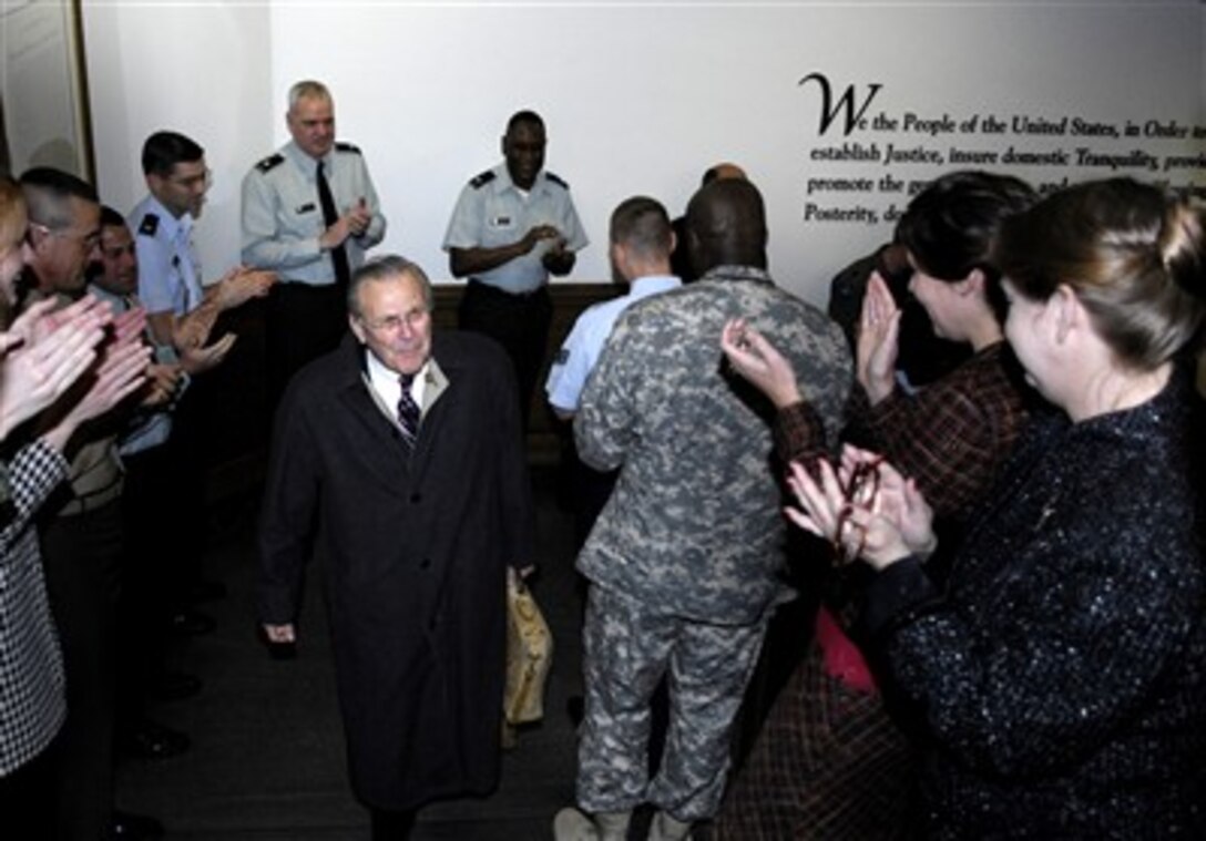 Defense Secretary Donald H. Rumsfeld receives applause from Defense Department employees as he arrives at the Pentagon on his final day in office, Dec. 15, 2006. 