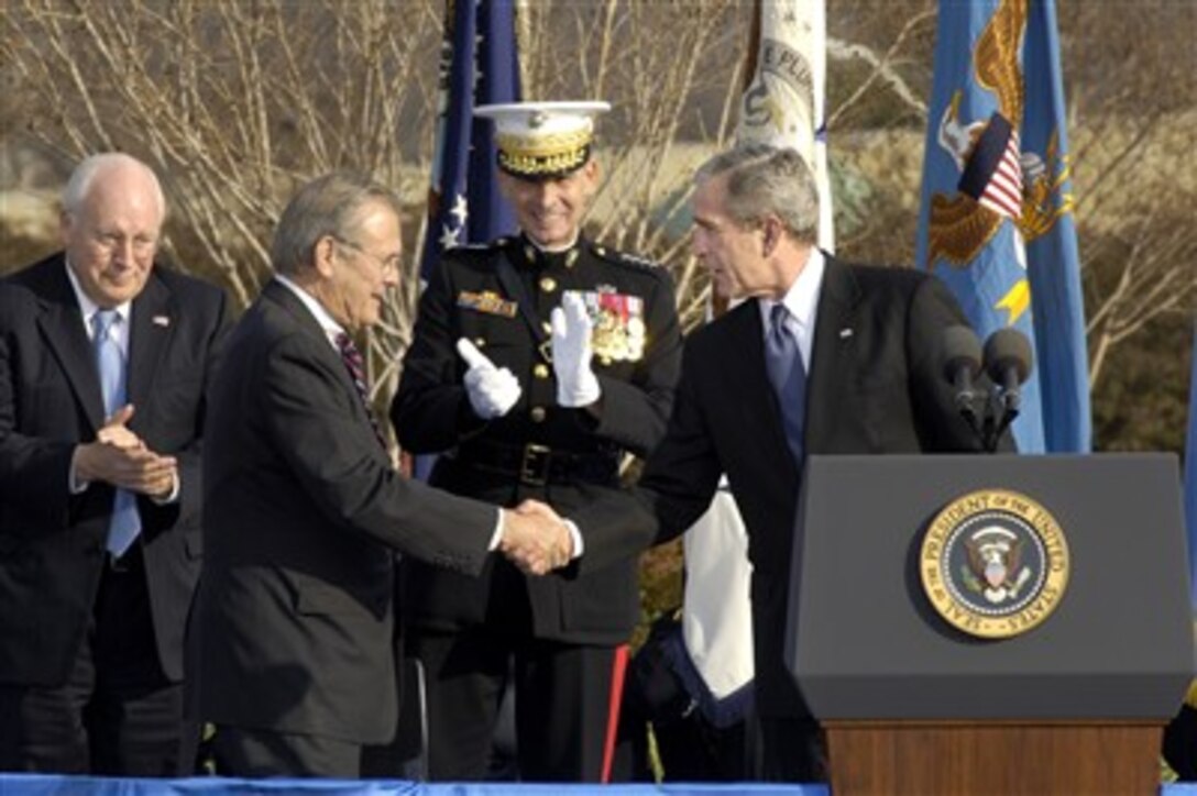 President George W. Bush congratulates outgoing Secretary of Defense Donald H. Rumsfeld on a job well done during Pentagon ceremonies, Dec. 15, 2006, bidding farewell to the man who has led the Department of Defense for the past six years.