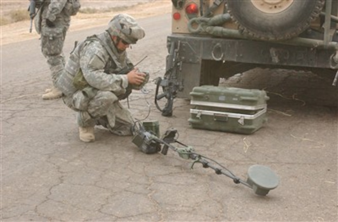 U.S. Army Spc. Ruben Aguilar gets a mine detector ready for use during a patrol near Mussayyib in Babil province in Iraq on Dec. 7, 2006.  Aguilar is assigned as a paratrooper to D company, 1st Battalion, 501st Parachute Infantry Regiment.  