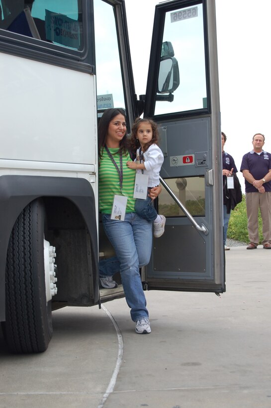 Jennifer Funkhouser holds her daughter, Allison, as she steps off the bus after arriving at the Oakley party Dec. 16. The party took place during the second day of the four-day Snowball Express event. The final two days of Snowball Express include a trip to Disneyland and tickets to an Anaheim Ducks game. (U.S. Air Force photo/Staff Sgt. Jeremy Larlee)