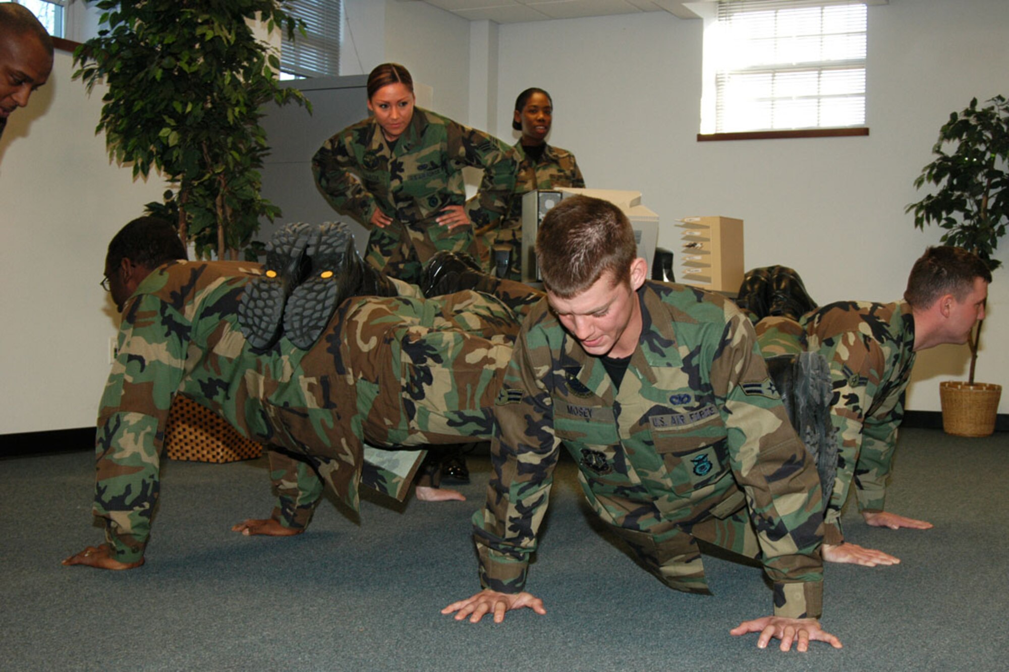 Senior Airman Darlin Garcia, 790th Missile Security Forces Squadron, oversees the four-man push-up.