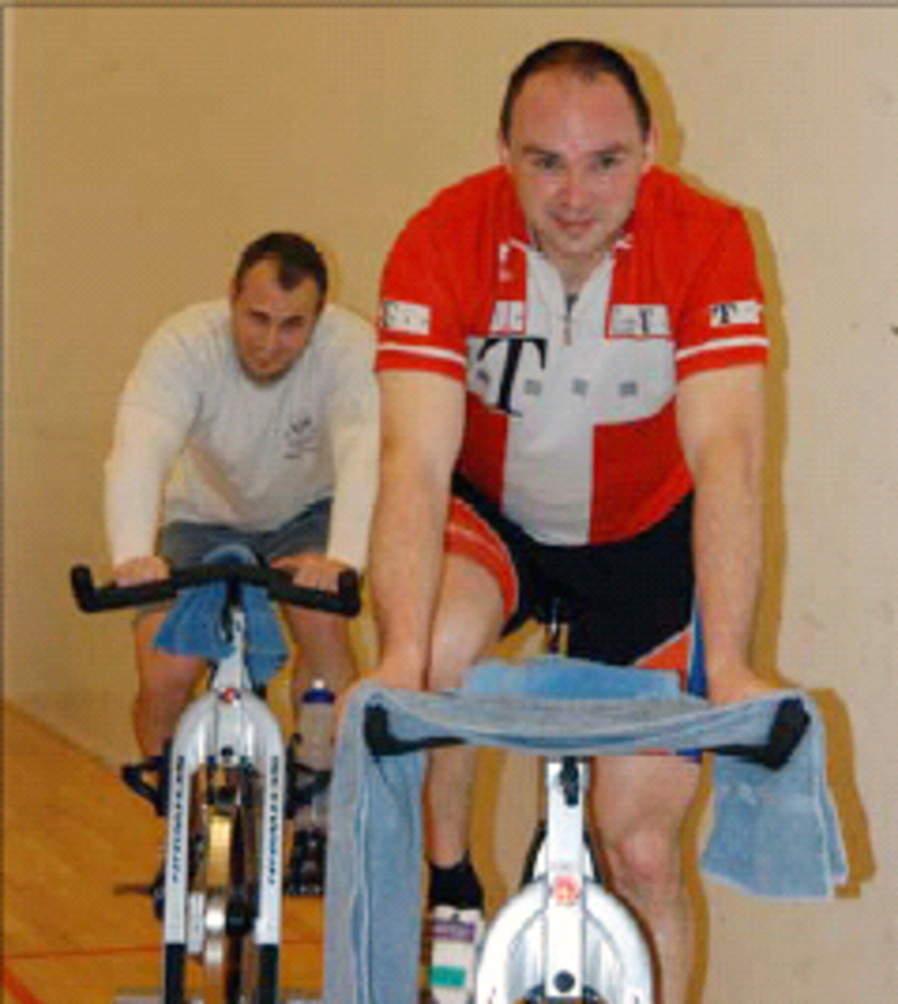 Lars Hoegner, Greenland contractor, (front) and Tech. Sgt. James McManus, 12th Space Warning Squadron, were two of three final riders for the six hour spinning marathon. The riders took turns riding for the six hours raising more than $150. The 12th SWS is one of Peterson’s geographically separated units, located at Thule Air Base, Greenland. (U.S. Air Force photo)