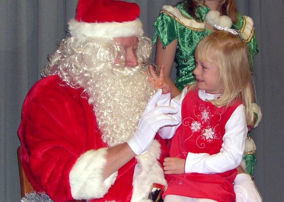 Kris Kringle, played by Brig. Gen. Bradley Butler, director of Logistics and Warfighting Integration AFSPC A4/6, listens to Savannah Uhl’s holiday wishes Dec. 2 at the Leadership Development Center. Santa, an elf and three live reindeer spread holiday cheer among the children, both young and old. 
After pictures with Santa, the crowd enjoyed cookies, face painting, cookie decorating and more at the directorate party. (U.S. Air Force photo by Capt. Horst Uhl)