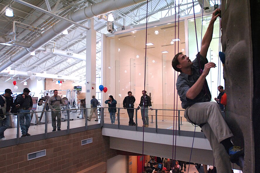 A climber tries out the new indoor rock climbing wall during Monday’s grand opening ceremony for Hill’s new state-of-the-art fitness center.